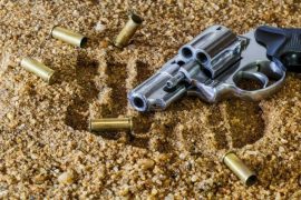 revolver-with-bullets-on-ground